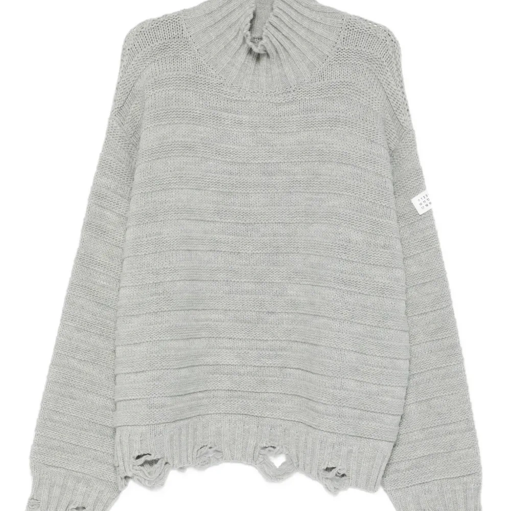 Свитер с высоким воротником и бахромой