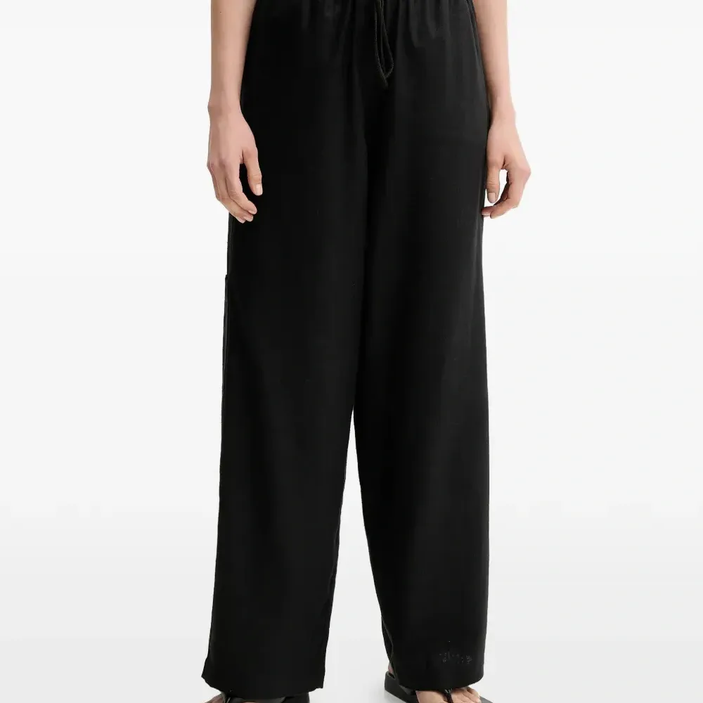 Льняные брюки с завязками и карманами