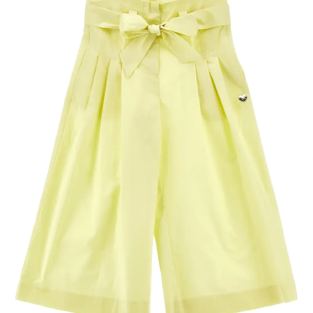 Брюки с бантом и складками